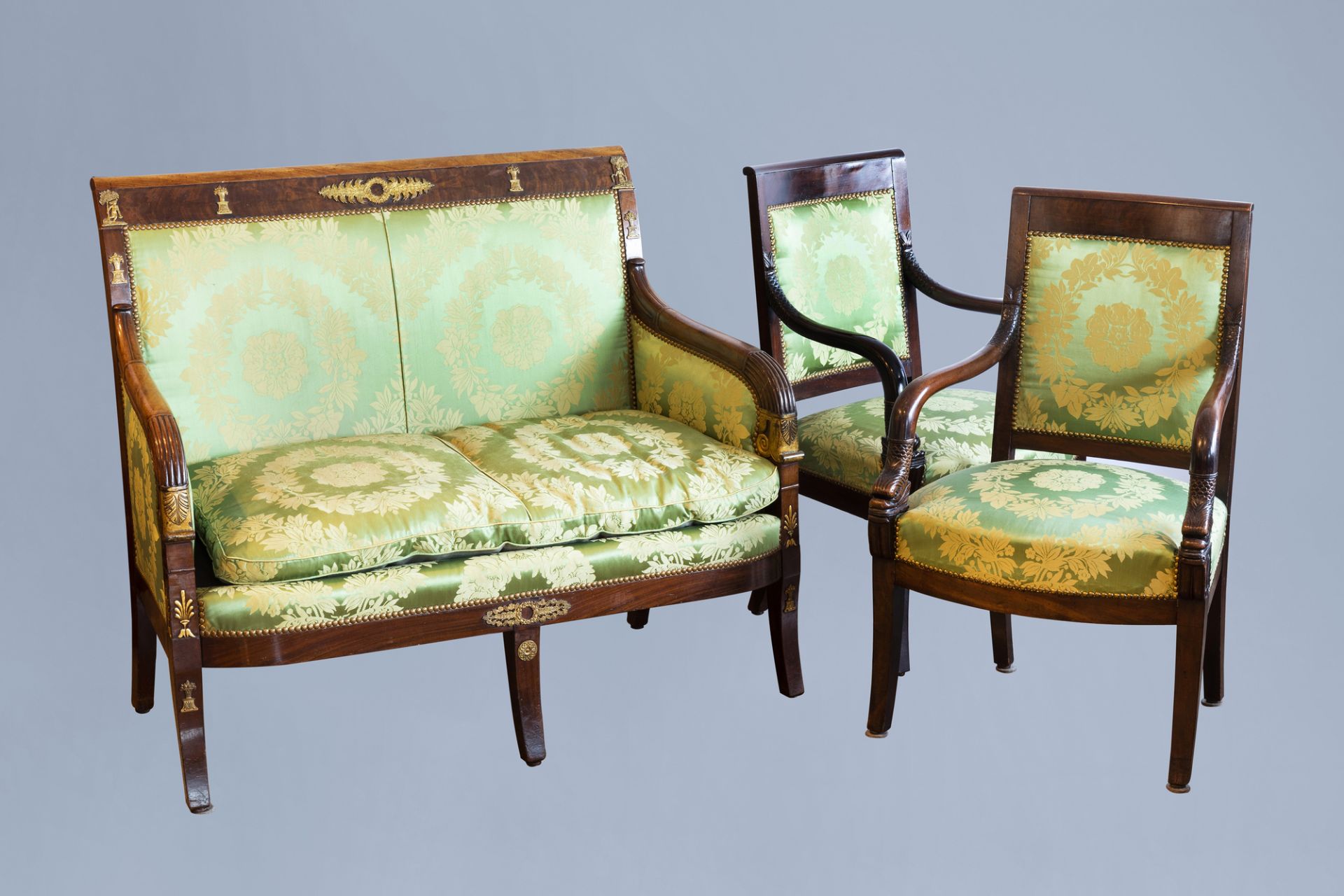 A French gilt bronze mounted mahogany and upholstered Restauration style three-piece salon set, 19th