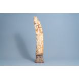 A French Gothic revival carved ivory group of Madonna and Child on an oak wooden base, probably atel