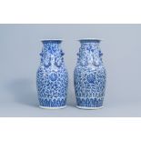 A pair of Chinese blue and white 'lotus scroll' vases with relief design, 19th C.