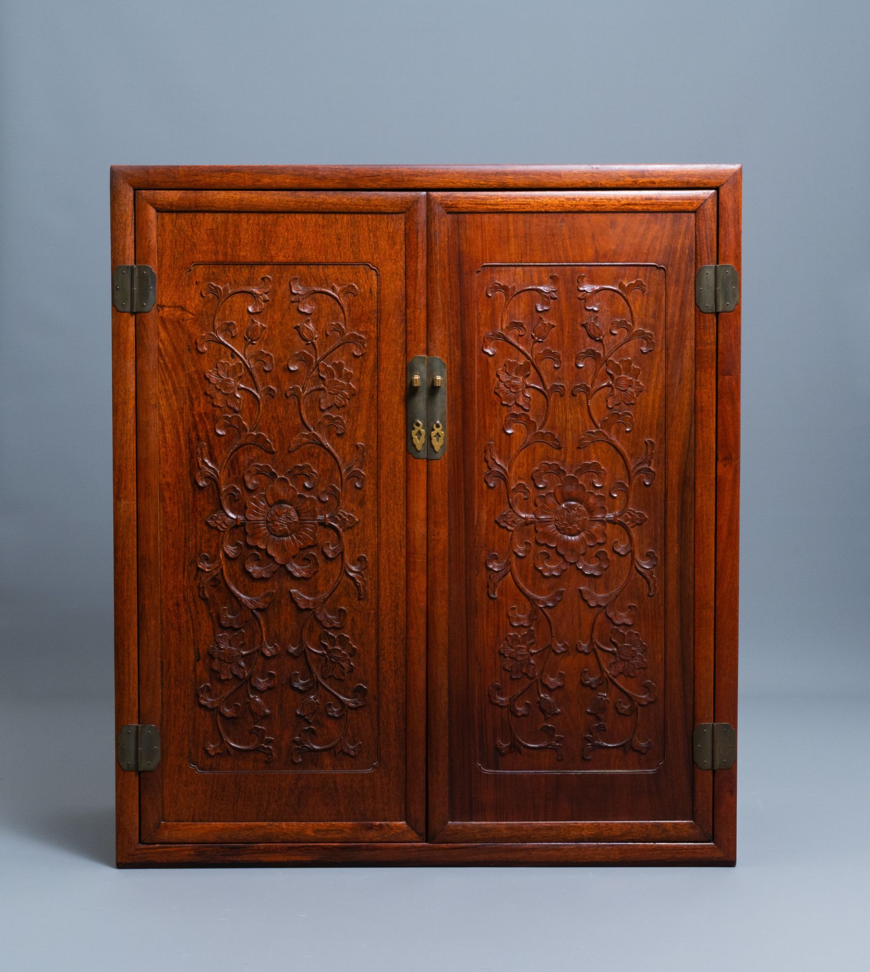 A Chinese wooden two-door cupboard with carved floral panels, 19th C. - Image 5 of 12