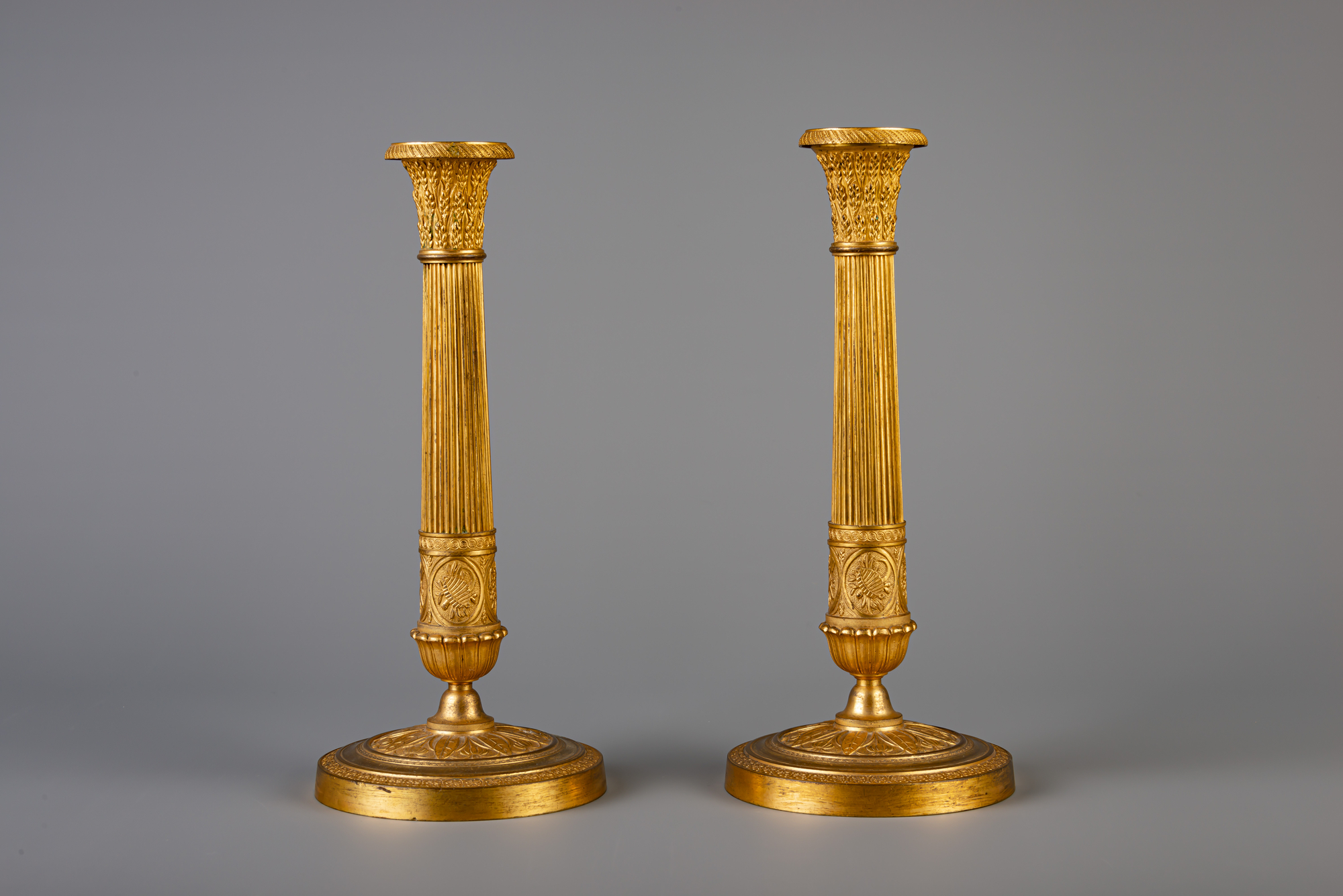 A pair of French Neoclassical gilt bronze candlesticks, 19th C. - Image 2 of 7