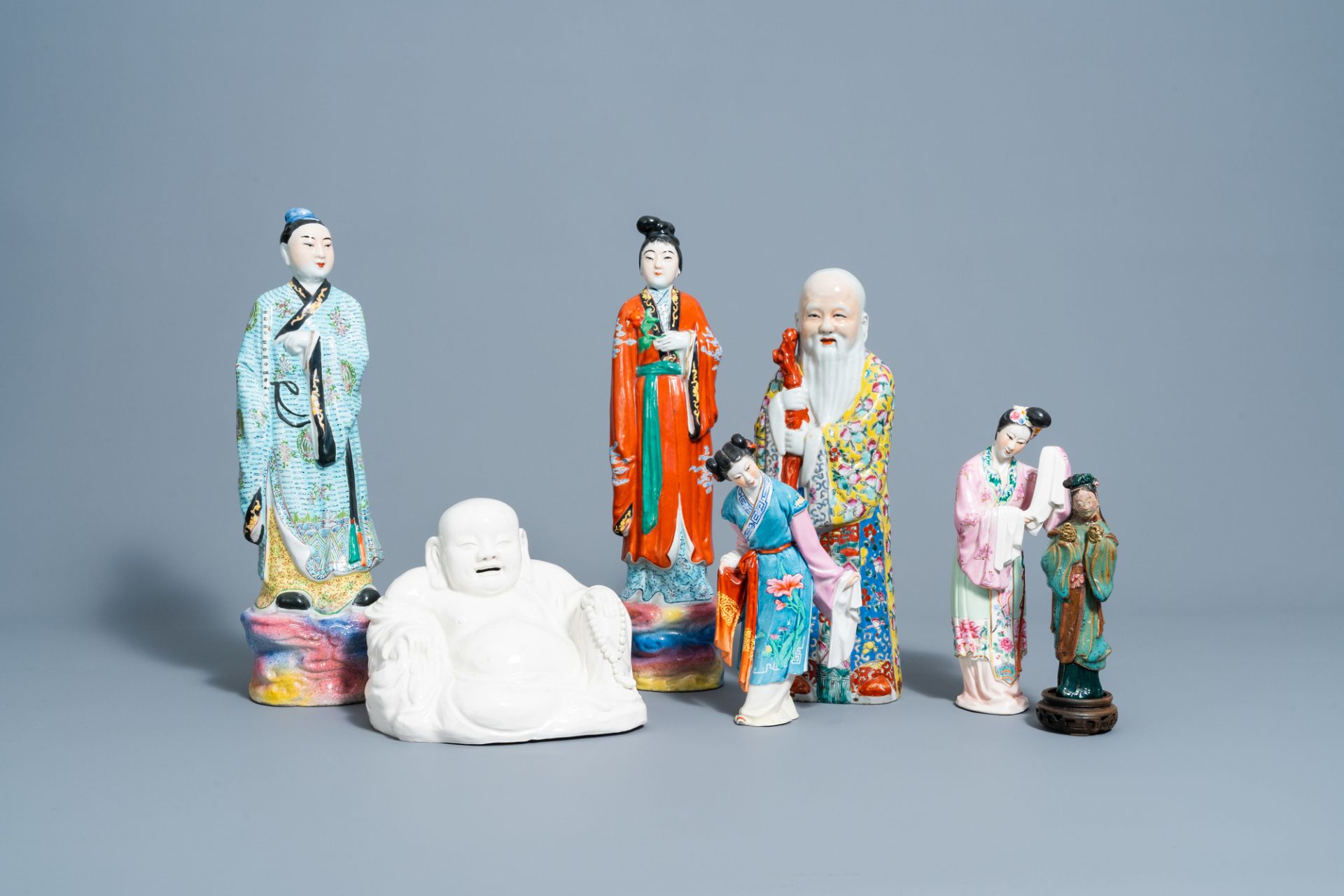Six various Chinese famille rose and blanc de Chine figures and an earthenware lady, 20th C.