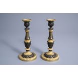 A pair of French gilt and patinated bronze candlesticks with acanthus leaves, 19th C.
