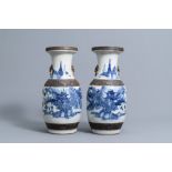 A pair of Chinese blue and white Nanking crackle glazed vases with an animated landscape all around,