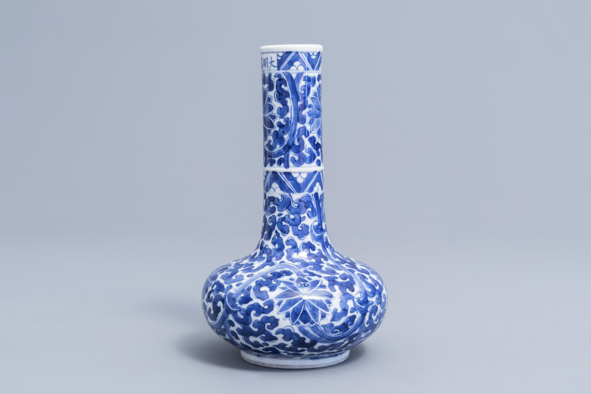 A Chinese blue and white 'lotus scroll' bottle vase, Wanli mark, 19th C. - Image 2 of 6