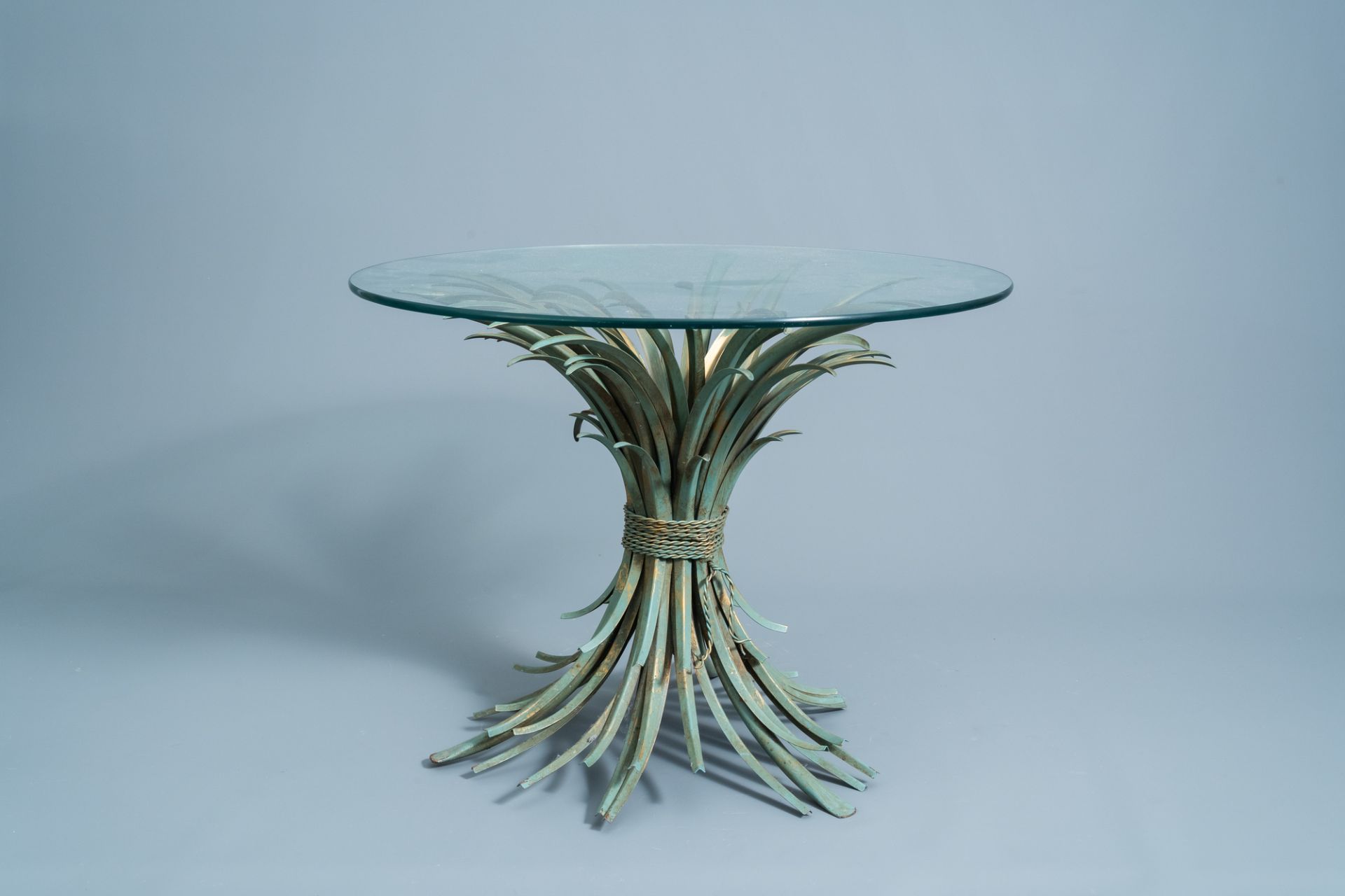 A vintage Coco Chanel style patinated metal coffee table with glass top, second half of the 20th C.