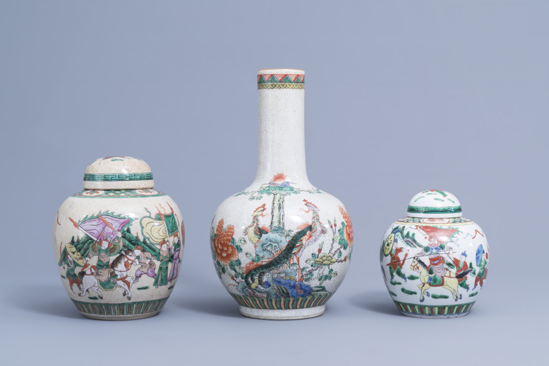 A Chinese bottle shaped Nanking crackle famille verte vase and two warrior jars, 19th/20th C.