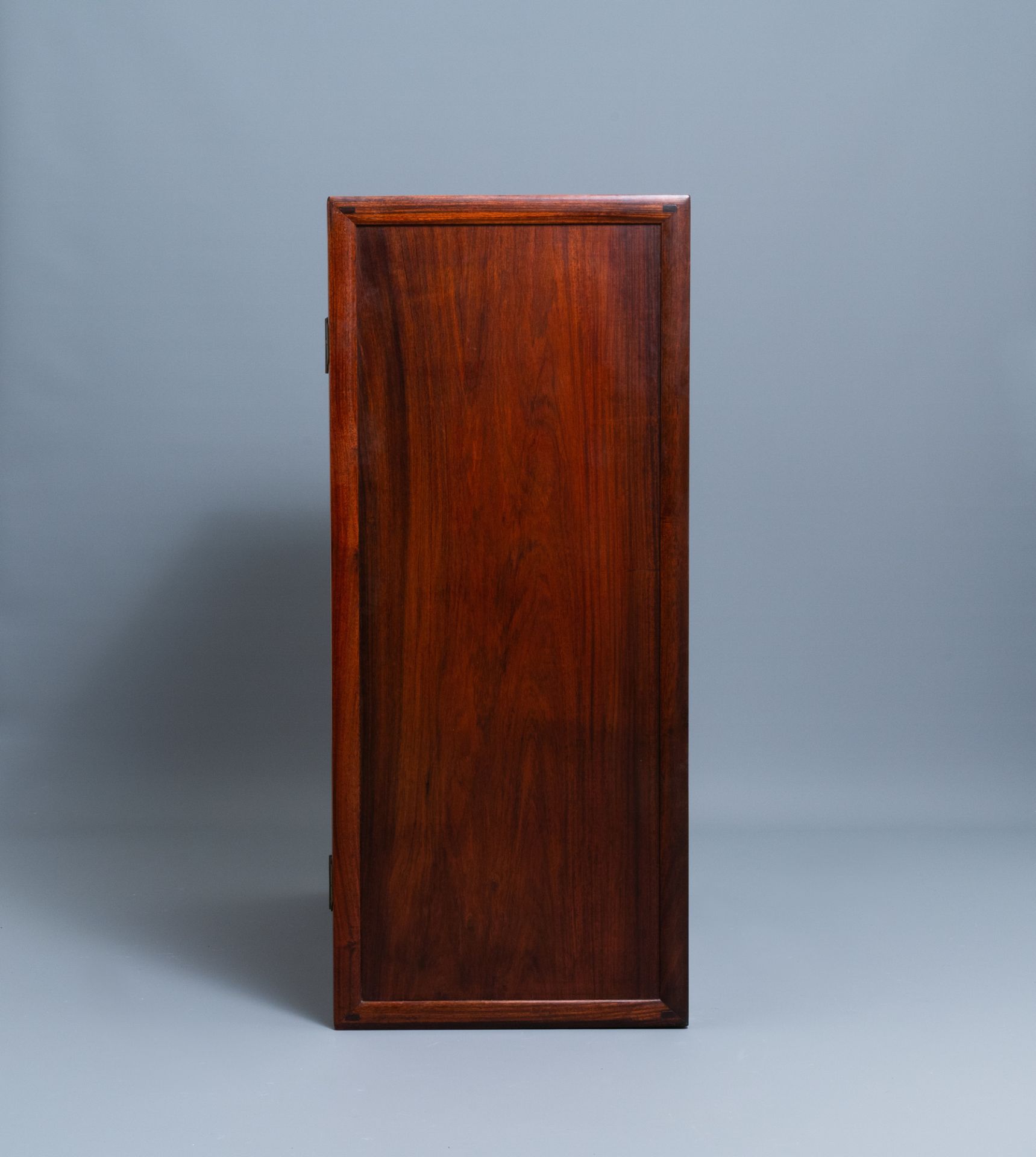 A Chinese wooden two-door cupboard with carved floral panels, 19th C. - Image 8 of 12