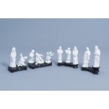 Ten various Chinese blanc de Chine figures on a wooden base, 20th C.