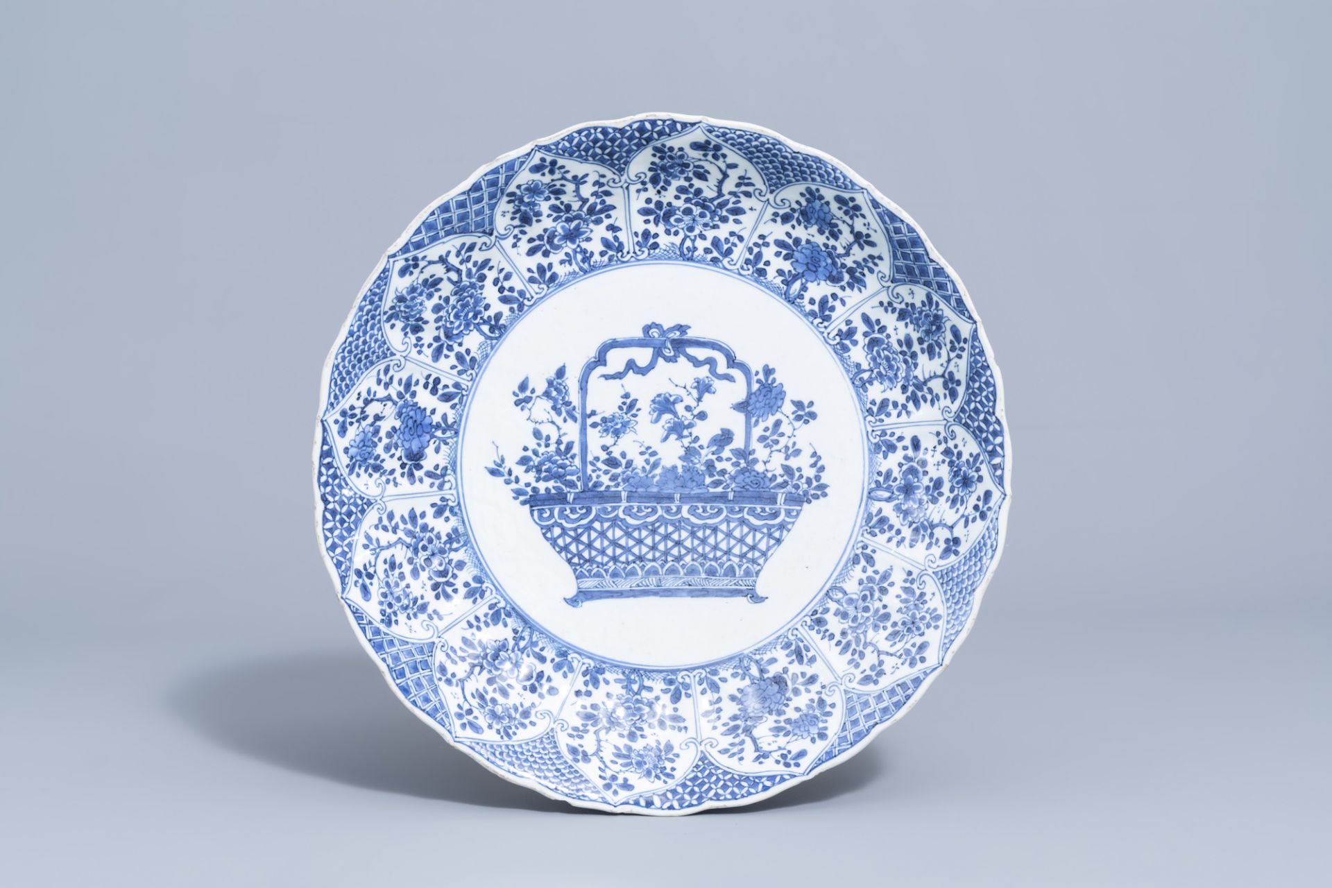 A lobed Chinese blue and white charger with a flower basket and floral design, Kangxi