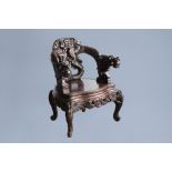 A Chinese or Japanese carved wooden 'dragons' chair, 20th C.