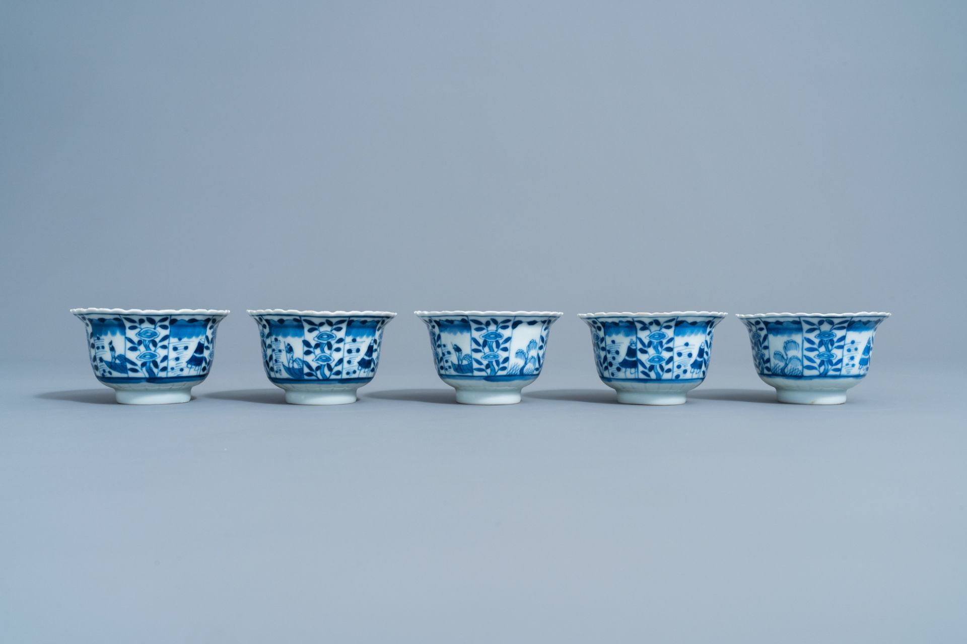 Five Chinese blue and white cups and saucers with landscapes and floral design, Kangxi mark, 19th C. - Image 7 of 9