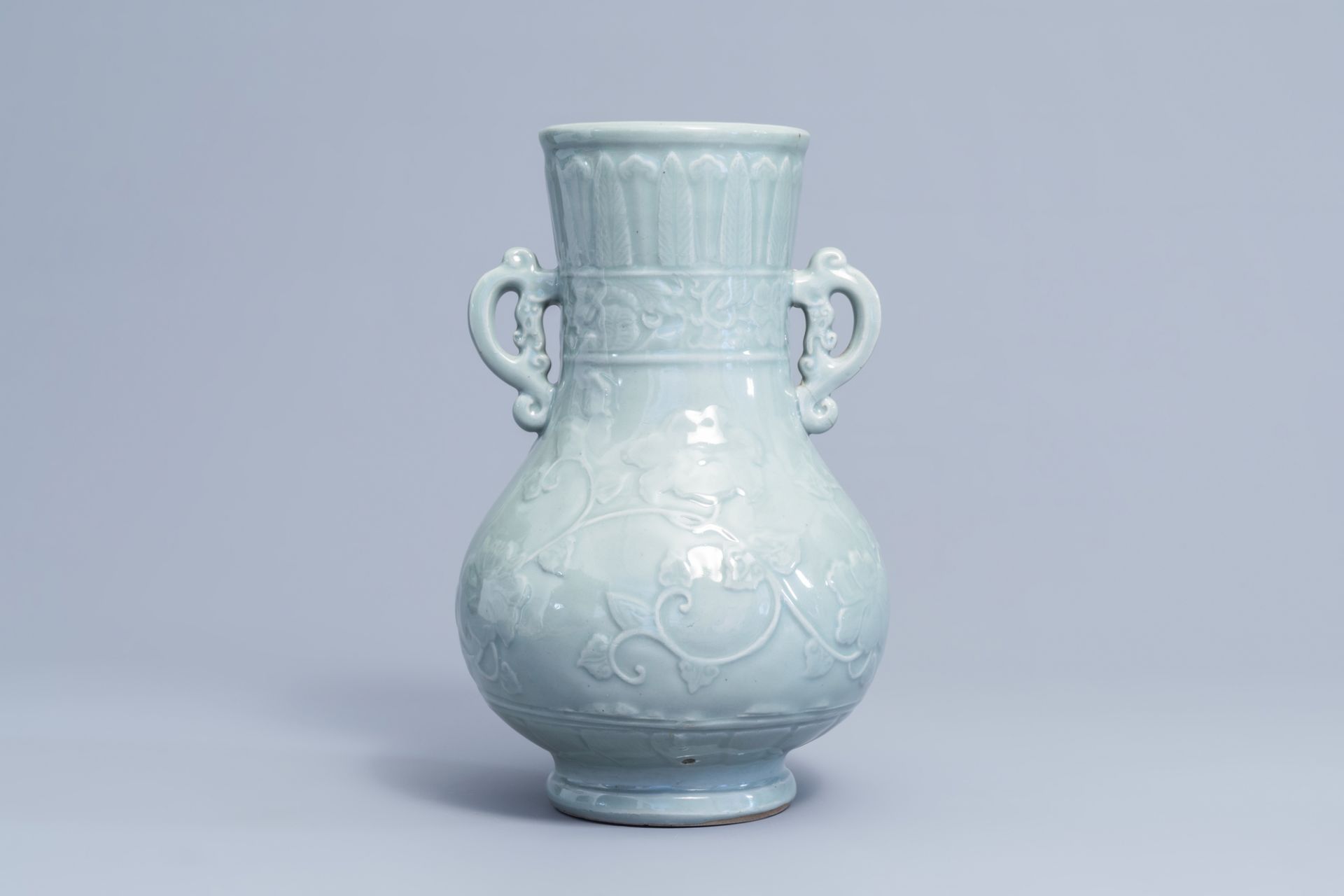 A Japanese celadon glazed 'lotus scroll' bottle vase, Edo/Meiji, 18th/19th C.