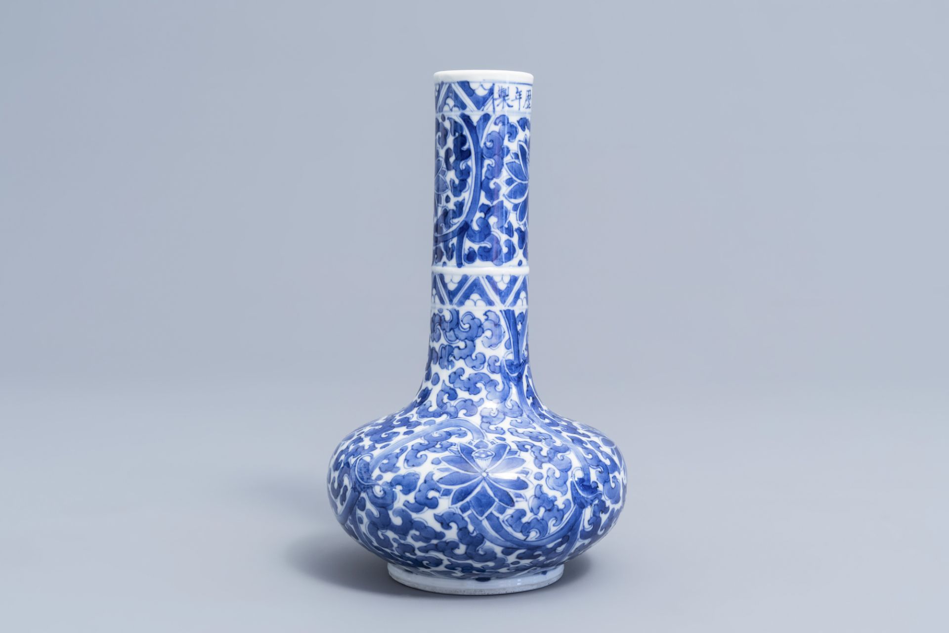 A Chinese blue and white 'lotus scroll' bottle vase, Wanli mark, 19th C. - Image 4 of 6