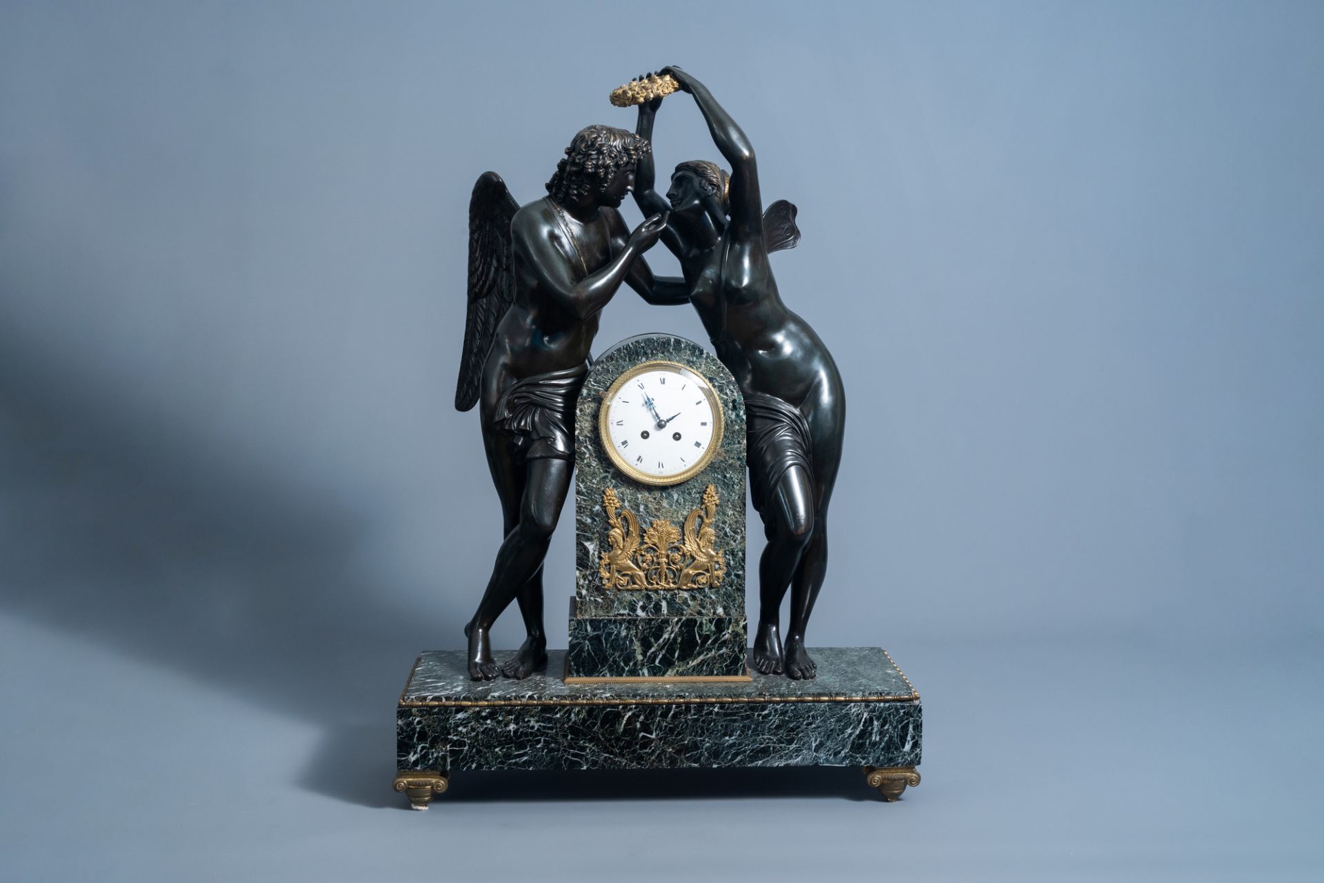 An impressive French patinated and gilt bronze mounted vert de mer marble Empire style mantel clock