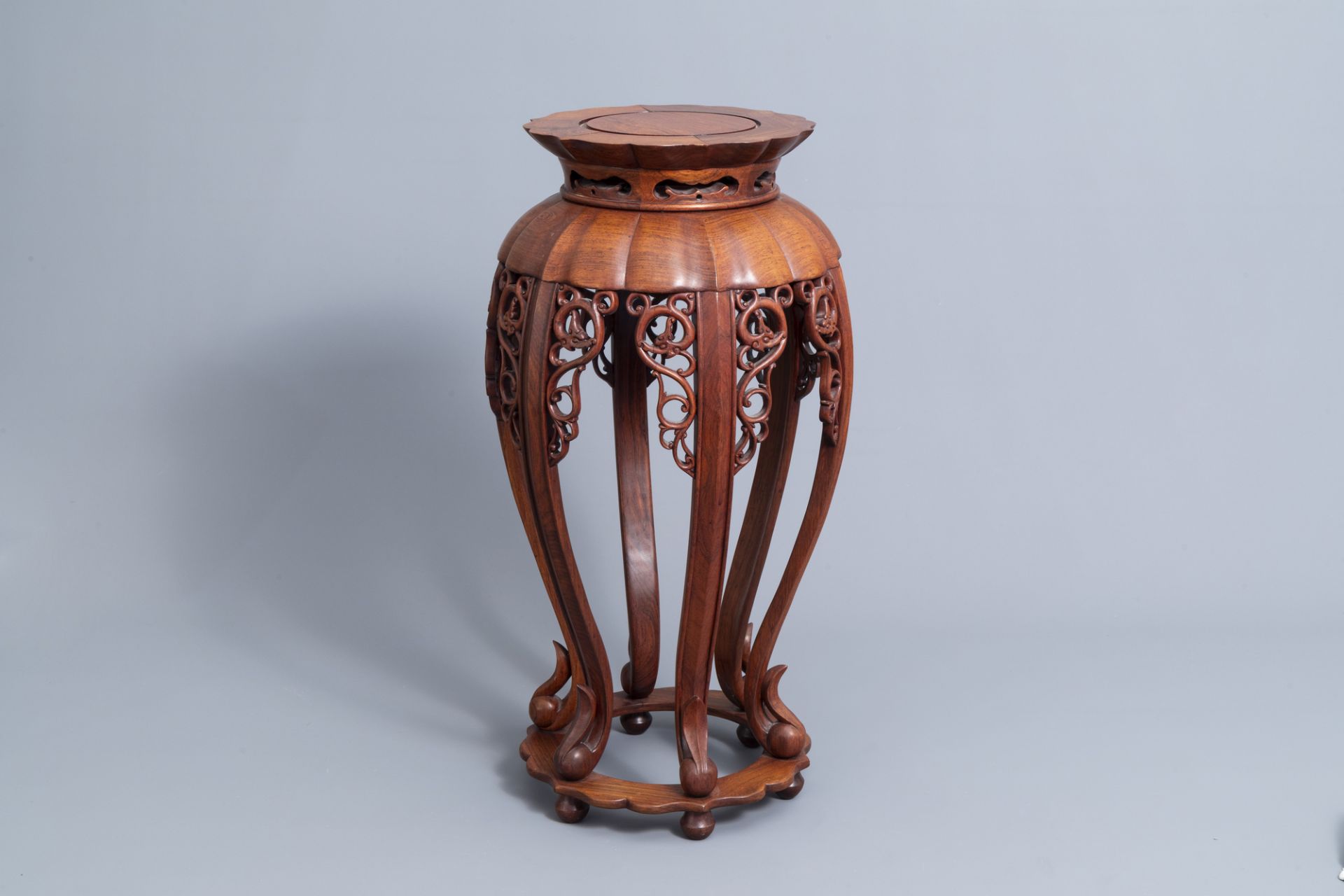 A Chinese carved wood stand with lotus shaped top, 20th C.