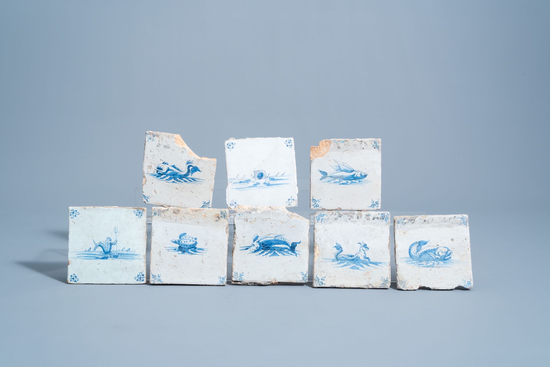Eight Dutch Delft blue and white 'sea monster' tiles, 17th C.