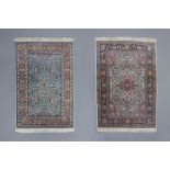 Two Oriental rugs with floral design, silk on cotton, 20th C.