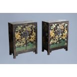 A pair of Chinese black lacquered wooden 'dragons chasing the pearl' two-door cabinets, 20th C.