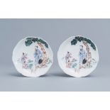 A pair of Chinese famille rose lotus shaped saucers with a scholar and his apprentices, Yongzheng