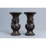 A pair of Japanese bronze relief decorated 'dragon' vases, Meiji, 19th C.