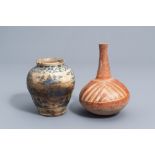 A South American bottle vase and a Syrian or Iranian storage jar with floral design, 19th C. and/or