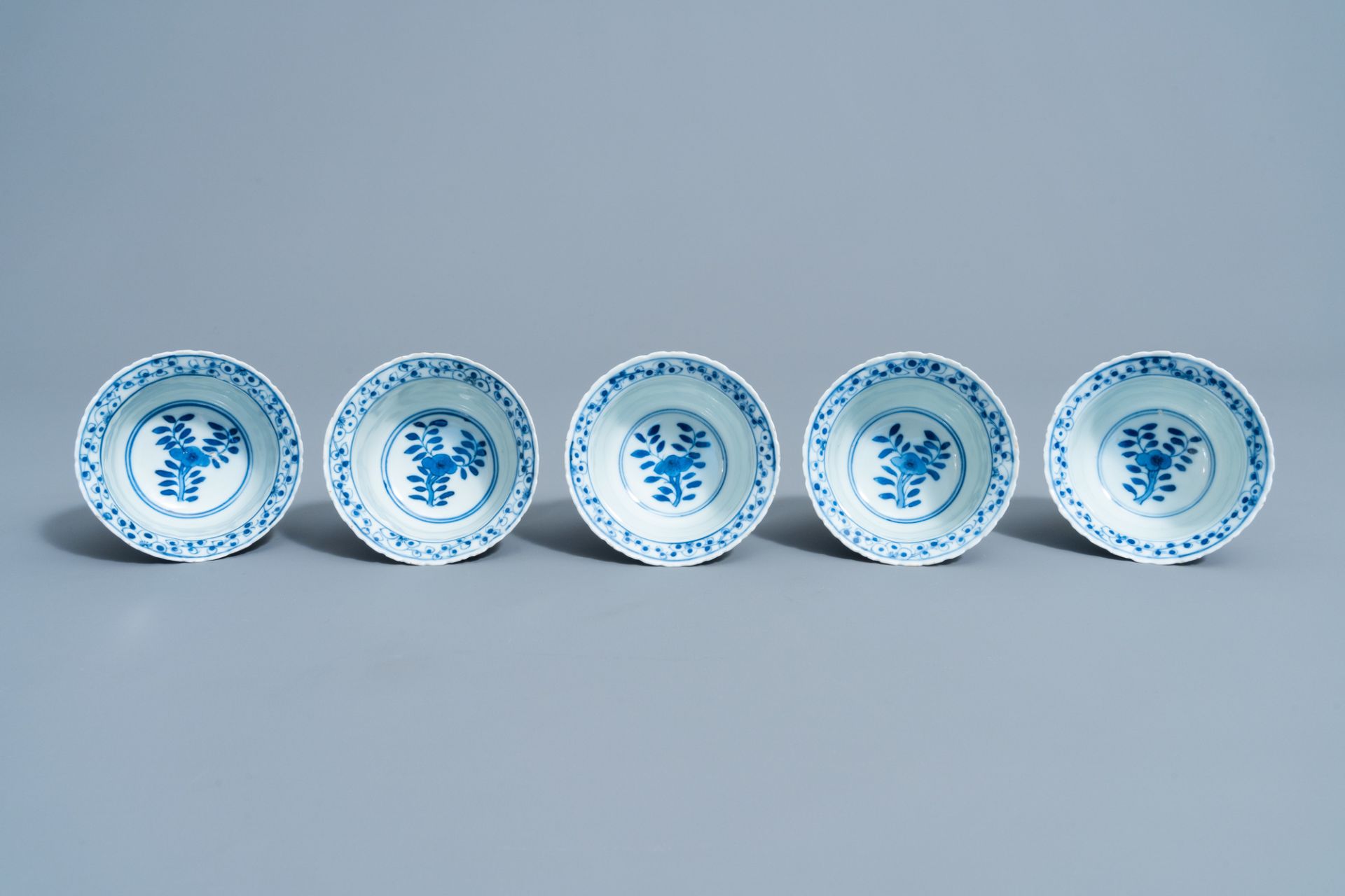 Five Chinese blue and white cups and saucers with landscapes and floral design, Kangxi mark, 19th C. - Image 8 of 9