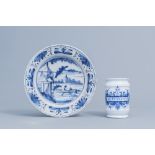 A Dutch Delft blue and white plate with an animated river landscape and a pharmacy jar, 18th C.