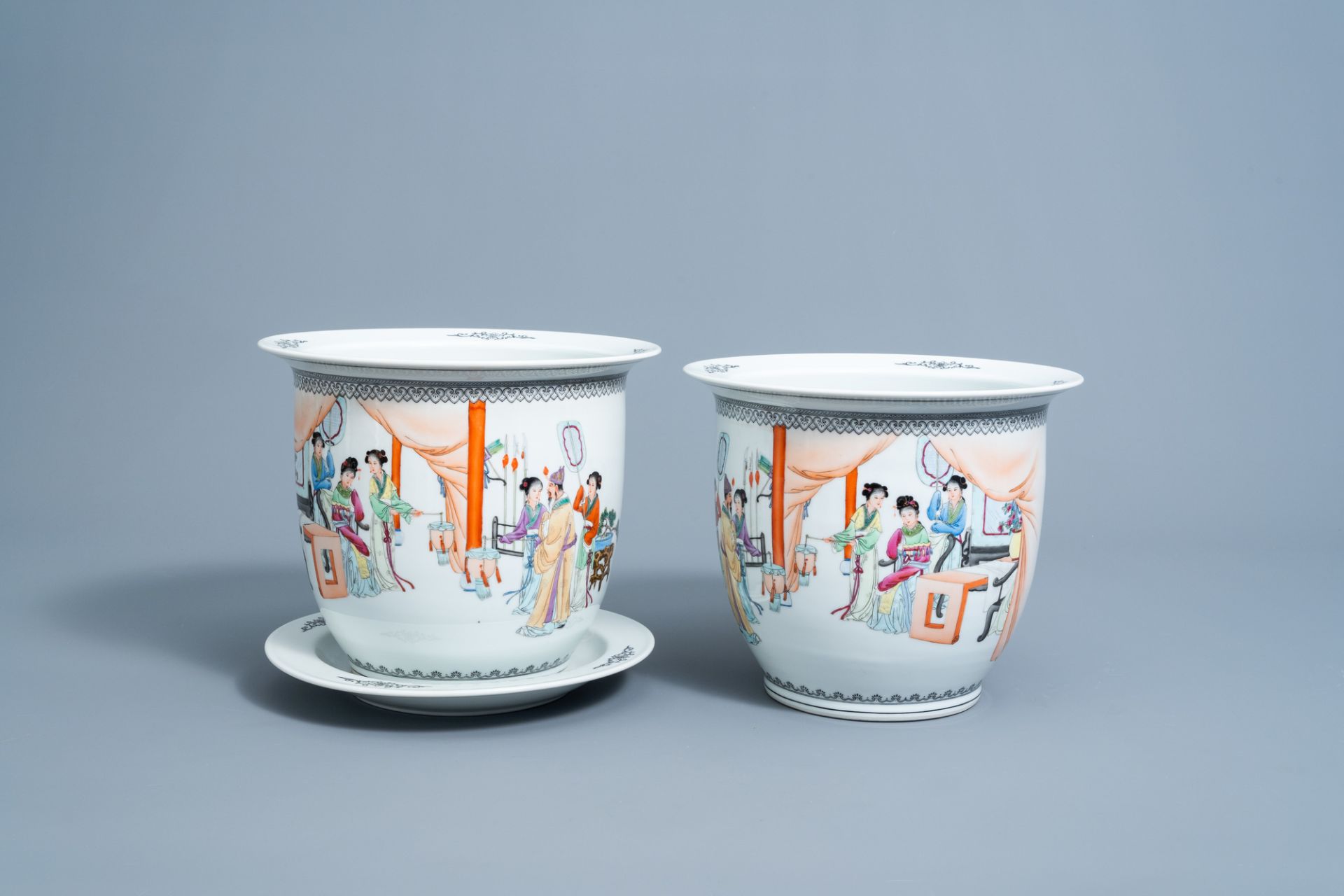 A pair of Chinese famille rose jardinieres with figures in an interior and a stand, Republic, 20th C