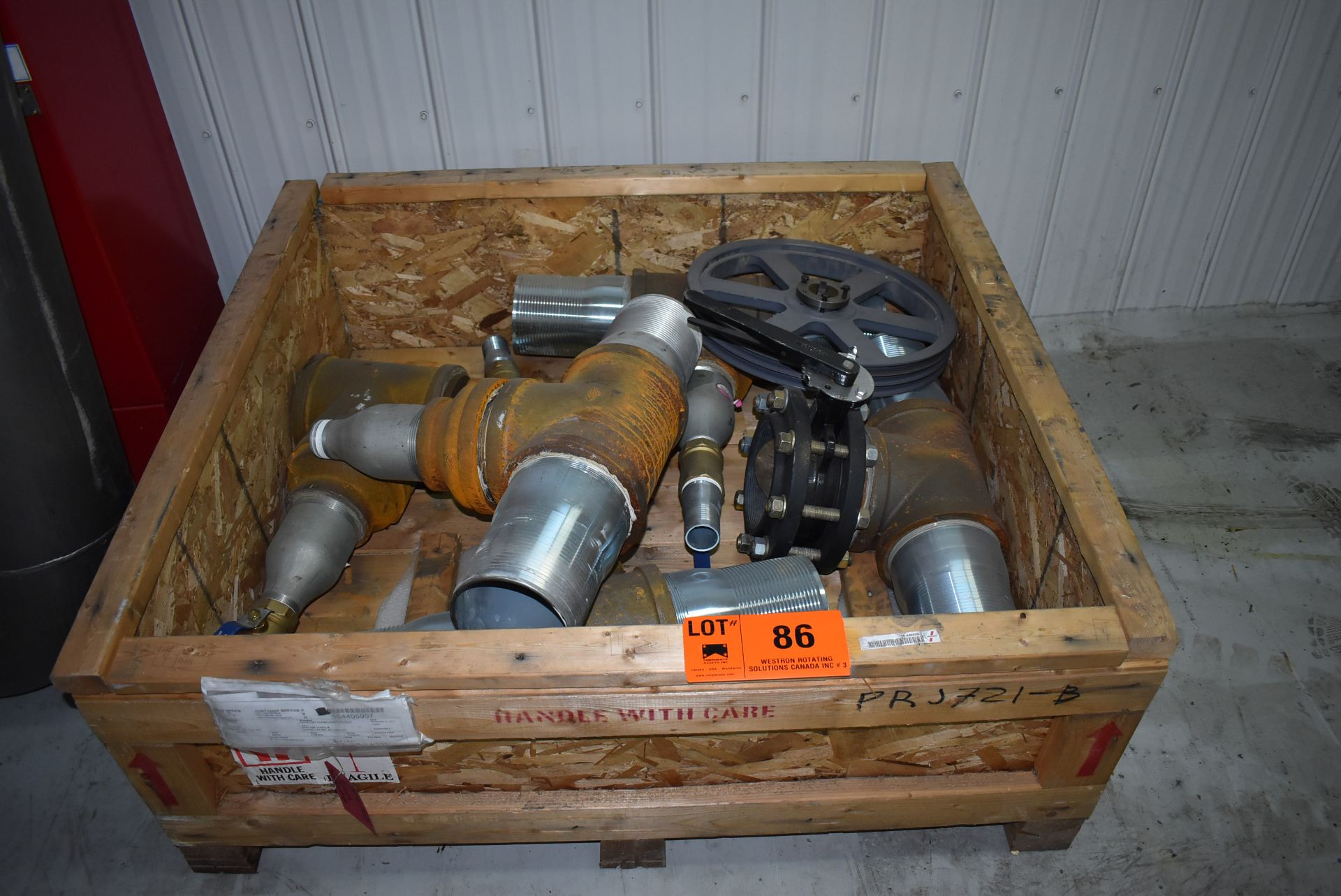 LOT/ CRATE WITH EXHAUSTS & FLYWHEEL (CI) [RIGGING FEE FOR LOT #86 - $25 CAD PLUS APPLICABLE TAXES]