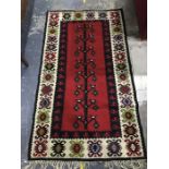 Modern Eastern style rug in reds, blacks, creams, blues, greens, 174 x 98 cm