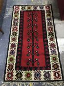 Modern Eastern style rug in reds, blacks, creams, blues, greens, 174 x 98 cm