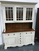 Modern dresser, cream painted with three glazed doors enclosing shelves, above sideboard of seven