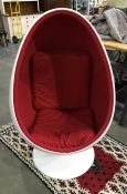 In the manner of Eero Aarnio egg pod chair with white plastic outer and red fabric inner