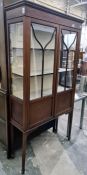 19th century mahogany and satinwood strung display cabinet, the ogee moulded cornice above two