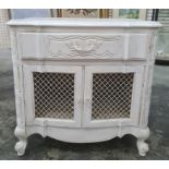 20th century white painted cupboard, the shaped top above single drawer, two grilled cupboard doors,