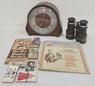 Pair of racing glasses with leather sleeves, a mantel clock in oak case, a vintage recipe book and