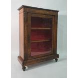 19th century walnut bookcase, the single glazed door enclosing shelves, on plinth base, turned feet,