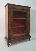 19th century walnut bookcase, the single glazed door enclosing shelves, on plinth base, turned feet,