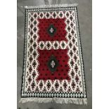 Eastern style rug in reds, creams, blacks and greens
