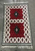 Eastern style rug in reds, creams, blacks and greens