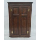 19th century oak corner cupboard of two doors, with brass H-shaped hinges, 112cm high