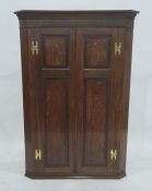 19th century oak corner cupboard of two doors, with brass H-shaped hinges, 112cm high