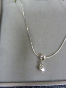 Solitaire diamond drop pendant, claw set in silver mount, on fine chain, the stone approx 0.10ct