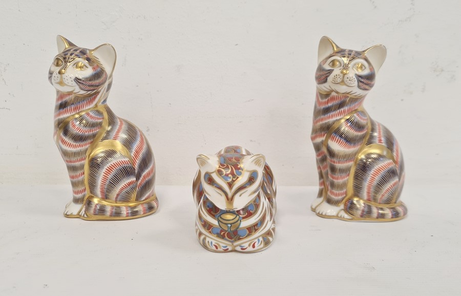 Two Royal Crown Derby seated cat paperweights and another cat lying down (3)Condition Reportthere is