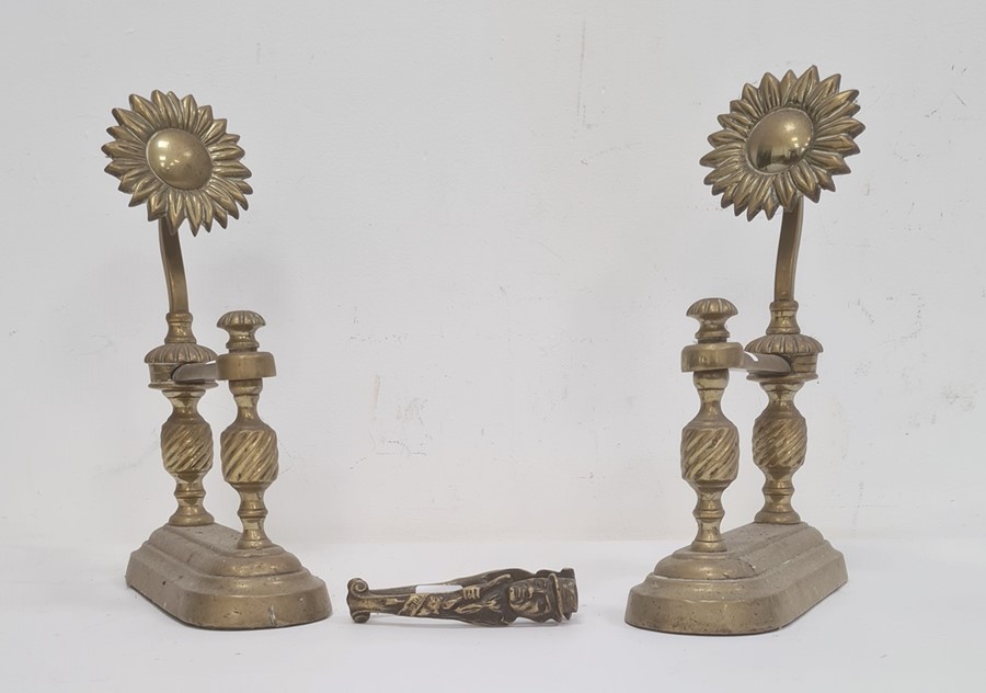 Pair of brass sunflower pattern firedogs, each with spiral turned columns and a pair of Fagin & Bill