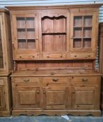 20th century pine dresser, the moulded cornice above two glazed doors, open shelves and three