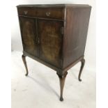20th century mahogany cabinet with single drawer above two cupboard doors, on cabriole supports,