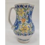 Continental faience pottery large jug with blue, yellow and orange floral and foliate decoration,