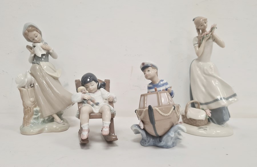 Lladro figure of girl with two doves, another of boy with boat, another of girl with doll in rocking